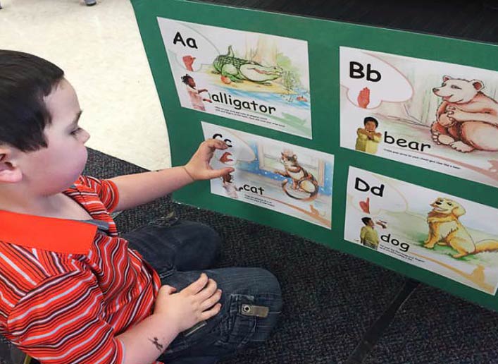 Teach children to sing, sign, fingerspell